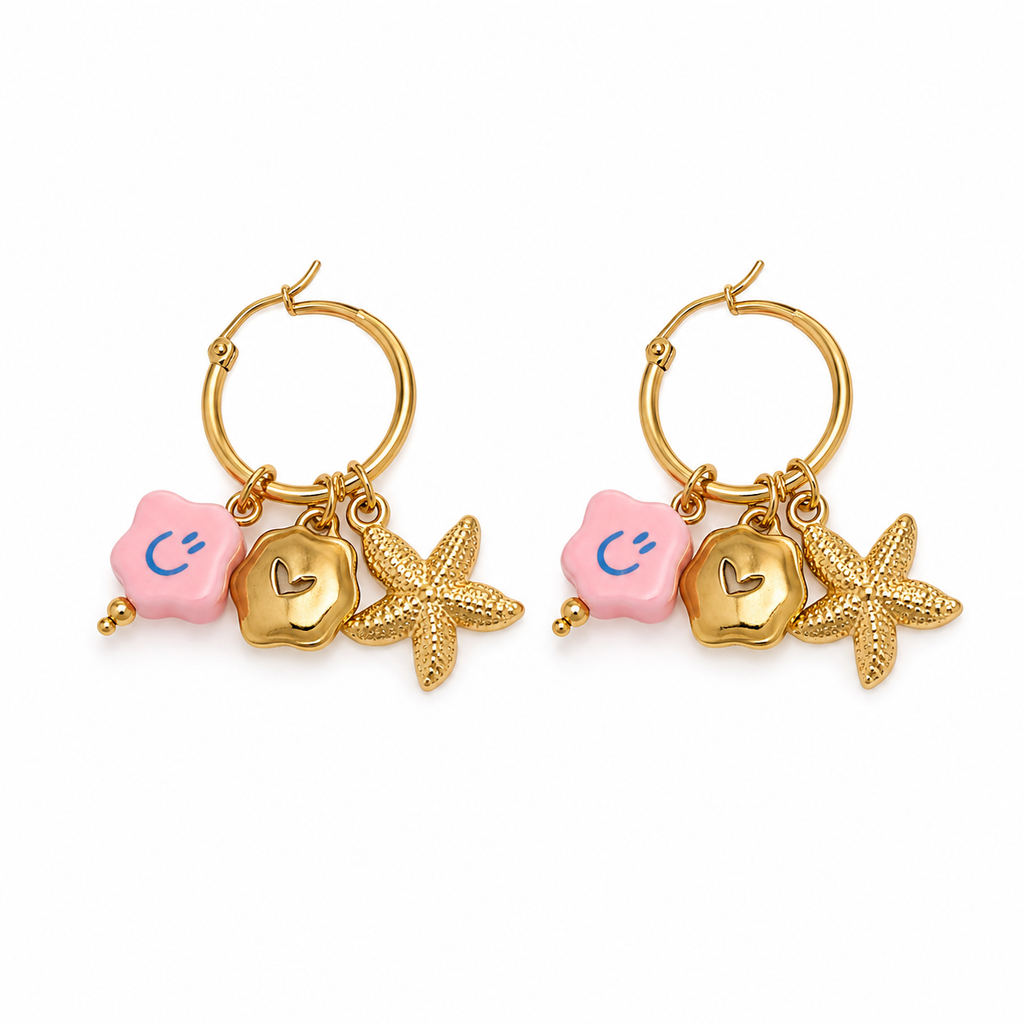 Pair of gold hoop earrings with starfish and pink hexagonal charms on a white background