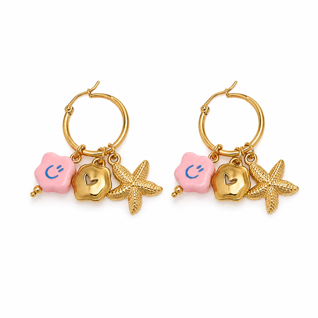 Pair of gold hoop earrings with starfish and pink hexagonal charms on a white background